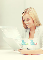 Image showing businesswoman looking at tablet pc