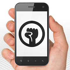 Image showing Politics concept: Hand Holding Smartphone with Uprising on display