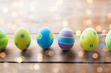 Image showing close up of colored easter eggs on wooden surface