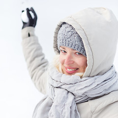 Image showing Girl snowball fighting in winter time.