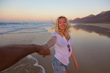 Image showing Romantic couple, holding hands, having fun on beach.