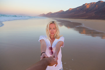 Image showing Romantic couple, holding hands, having fun on beach.