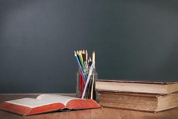 Image showing School desk with blackboard