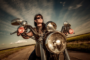 Image showing Biker girl on a motorcycle