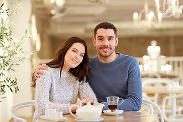 Image showing happy couple drinking tea at restaurant