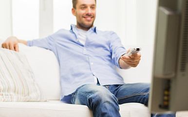 Image showing close up of man with tv remote control at home
