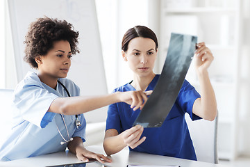 Image showing female doctors with x-ray image at hospital