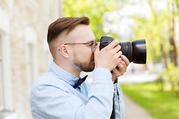 Image showing young hipster man with digital camera in city