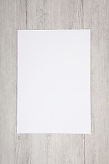 Image showing white paper on wood background