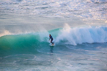 Image showing Senior surfer riding a perfect wave.