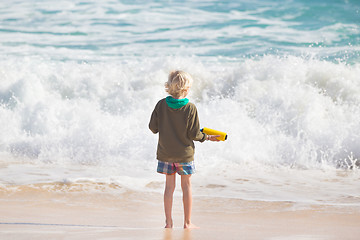 Image showing Boy playing with toys on beach.