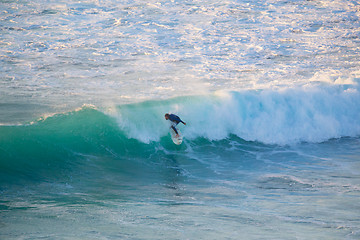 Image showing Senior surfer riding a perfect wave.