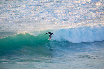 Image showing Senior surfer riding a perfect wave.