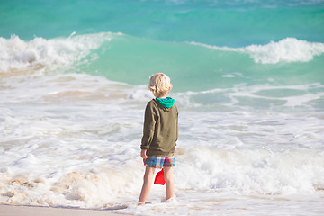 Image showing Boy playing with toys on beach.