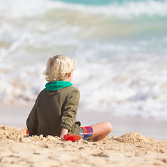 Image showing Boy playing with toys on beach.