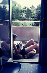 Image showing Original vintage colour slide from 1960s, young woman relaxing a