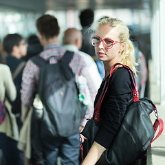 Image showing Young blond caucsian woman waiting in line.