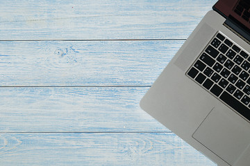 Image showing Laptop on a blue wooden desk