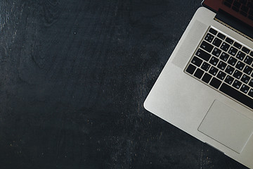 Image showing Laptop on the black wooden desk