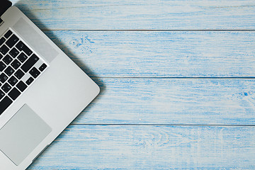 Image showing Laptop on a blue wooden desk