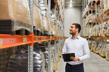 Image showing businessman with clipboard at warehouse