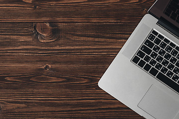 Image showing Laptop on the brown wooden desk