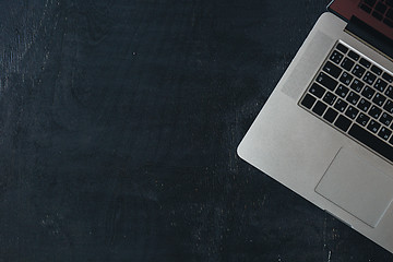 Image showing Laptop on the black wooden desk