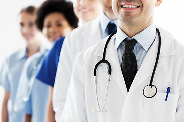 Image showing close up of happy doctors with stethoscope