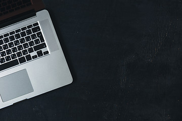 Image showing Laptop on the black wooden desk