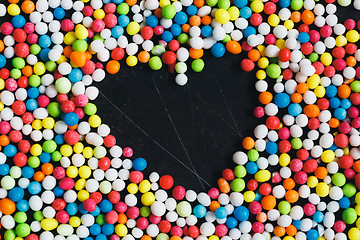 Image showing Colorful Sugar Balls with heart of emptiness .