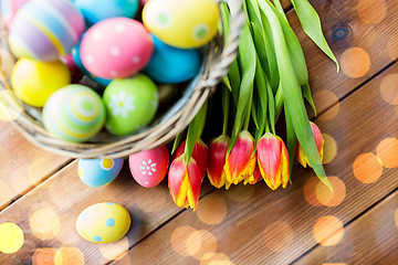 Image showing close up of easter eggs in basket and flowers