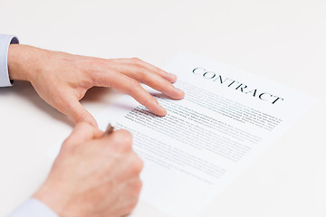 Image showing close up of male hands signing contract document