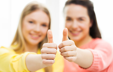 Image showing  happy teenage girls showing thumbs up