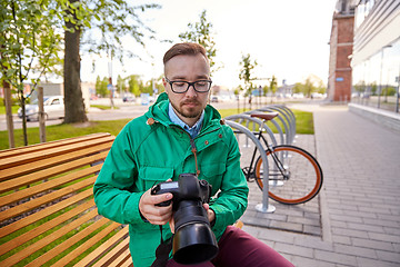 Image showing young hipster man with digital camera in city