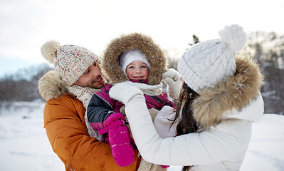 Image showing happy family with child in winter clothes outdoors