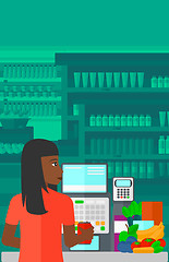 Image showing Cashier at supermarket checkout.