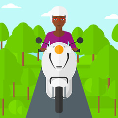 Image showing Woman riding scooter.