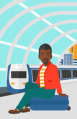 Image showing Man sitting on railway platform.