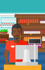 Image showing Salesman standing  at checkout.