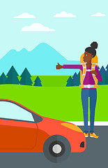 Image showing Young woman hitchhiking.