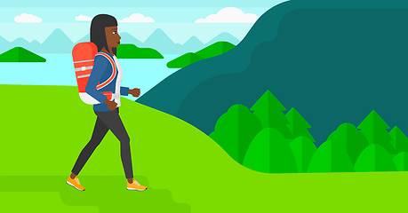 Image showing Woman with backpack hiking.