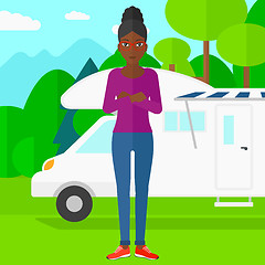 Image showing Woman standing in front of motor home.