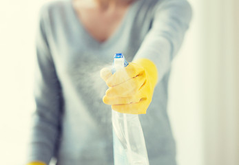 Image showing close up of happy woman with cleanser spraying