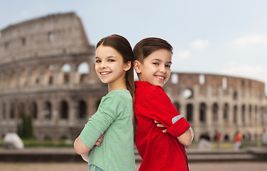 Image showing happy boy and girl standing over coliseum in rome