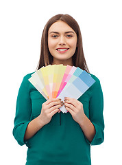 Image showing smiling young woman with color swatches