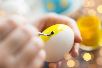 Image showing close up of woman hands coloring easter eggs