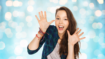 Image showing happy laughing pretty teenage girl showing hands