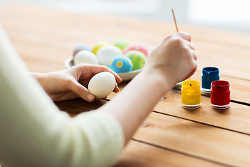 Image showing close up of woman coloring easter eggs