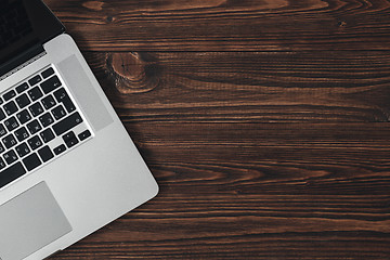 Image showing Laptop on the brown wooden desk