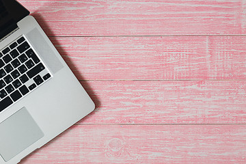 Image showing Laptop on a pink wooden desk